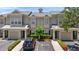 Townhouse exterior with a two-car garage and green landscaping at 7593 Plantation Cir, Bradenton, FL 34201