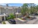 Inviting exterior view of townhome featuring a covered parking and well-manicured landscaping at 7593 Plantation Cir, Bradenton, FL 34201