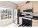 Bright kitchen featuring stainless appliances, granite countertops, and a window view at 7593 Plantation Cir, Bradenton, FL 34201