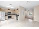 Well-lit kitchen with stainless steel appliances, tile floors and direct access to the living area at 7593 Plantation Cir, Bradenton, FL 34201