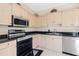 Kitchen with stainless steel appliances and light wood cabinetry at 7593 Plantation Cir, Bradenton, FL 34201