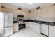 Functional kitchen featuring stainless steel appliances, light wood cabinets, and dark countertops at 7593 Plantation Cir, Bradenton, FL 34201
