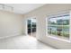 Light filled room with sliding glass doors to lanai with tranquil pond views at 7593 Plantation Cir, Bradenton, FL 34201
