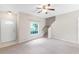 Bright living room featuring neutral paint, carpet, and a staircase leading upstairs at 7593 Plantation Cir, Bradenton, FL 34201