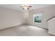 Bright living room featuring neutral walls, plush carpeting, ceiling fan, and natural light from a large window at 7593 Plantation Cir, Bradenton, FL 34201