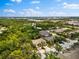 An aerial view of townhomes surrounded by lush greenery under a partly cloudy sky at 8209 72Nd E St, University Park, FL 34201