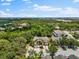 An aerial view of townhomes surrounded by lush landscaping, near shopping and commercial buildings at 8209 72Nd E St, University Park, FL 34201