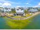 Aerial view showcasing the community's waterfront pavilion and beautiful green space surrounded by homes and shimmering water at 8209 72Nd E St, University Park, FL 34201
