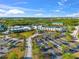 Aerial view of a building and parking lot surrounded by trees, and greenery on a clear sunny day at 8209 72Nd E St, University Park, FL 34201
