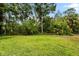 Lush backyard with mature trees and a spacious lawn area at 8209 72Nd E St, University Park, FL 34201