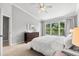 Inviting bedroom with a large window, soft carpet, and ceiling fan at 8209 72Nd E St, University Park, FL 34201