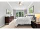 Cozy bedroom featuring a large window with green views, dresser, and stylish decor at 8209 72Nd E St, University Park, FL 34201