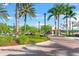 Brick walking path lined with palm trees and lush greenery, offering a serene outdoor experience at 8209 72Nd E St, University Park, FL 34201