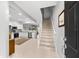 Inviting entryway with a staircase leading upstairs and a modern, open kitchen to the left at 8209 72Nd E St, University Park, FL 34201