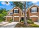 Attractive townhome featuring a two-car garage, appealing landscaping, and a tidy front yard at 8209 72Nd E St, University Park, FL 34201