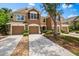 Inviting townhouse featuring a spacious driveway, a two-car garage, and well-maintained landscaping at 8209 72Nd E St, University Park, FL 34201