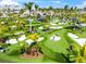 Vibrant mini golf course with players enjoying the manicured greens, palm trees, and sunny weather at 8209 72Nd E St, University Park, FL 34201