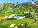 Lush mini golf course showcasing undulating greens, sand traps, and players enjoying a sunny day at 8209 72Nd E St, University Park, FL 34201