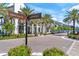 Intersection in upscale area with palm trees, shops, and direction signs at 8209 72Nd E St, University Park, FL 34201
