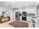 Modern kitchen featuring stainless steel appliances, light grey walls, and tile floors and countertops at 8209 72Nd E St, University Park, FL 34201