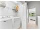 Well-lit laundry room with Maytag washer/dryer and shelving, conveniently located near bedroom at 8209 72Nd E St, University Park, FL 34201