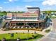 Outdoor seating area with charming decor, vibrant mural, and inviting ambiance for delightful dining at 8209 72Nd E St, University Park, FL 34201