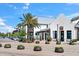 Retail spaces with palm trees lining the street and decorative planters at 8209 72Nd E St, University Park, FL 34201