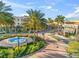 A town center featuring a water fountain, lush landscaping, outdoor dining and pedestrian walkways at 8209 72Nd E St, University Park, FL 34201