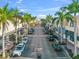 A street view of a pedestrian-friendly town center with palm trees, parallel parking and retail shops at 8209 72Nd E St, University Park, FL 34201