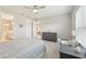 Spacious bedroom boasts a large window, gray dresser, and en suite bathroom with modern fixtures at 9970 Cross River Trl, Parrish, FL 34219