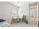 Well-lit bedroom with window, carpet, desk, and bookshelf for comfortable living and productive workspace at 9970 Cross River Trl, Parrish, FL 34219