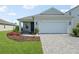 Charming single-Gathering home featuring a two-car garage, landscaped yard, and inviting front entrance at 9970 Cross River Trl, Parrish, FL 34219