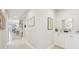 Inviting hallway with decorative accents, leading to various rooms in the home at 9970 Cross River Trl, Parrish, FL 34219