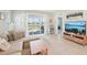 Bright living room with a sliding glass door leading to the screened patio at 9970 Cross River Trl, Parrish, FL 34219
