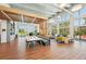 Open community space with wood floors, stylish furniture, large windows, and natural light at 9970 Cross River Trl, Parrish, FL 34219