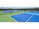 Outdoor pickleball courts with blue and green surfaces and black netting at 9970 Cross River Trl, Parrish, FL 34219