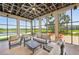 Relax in the inviting sitting area with comfortable seating and scenic lake views at 9970 Cross River Trl, Parrish, FL 34219
