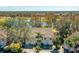 Aerial view of townhomes overlooking a pond and golf course in a lush, green community at 6748 Fairview Ter # 4-202, Bradenton, FL 34203
