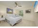 Cozy bedroom features a queen bed, ceiling fan, bright window, and comfortable furnishings at 6748 Fairview Ter # 4-202, Bradenton, FL 34203