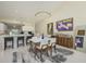 Dining area featuring an open floor plan, modern light fixture, bar area with wood cabinet, and contemporary decor at 6748 Fairview Ter # 4-202, Bradenton, FL 34203