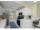 Bright kitchen features white cabinets, stainless appliances, a built-in desk space and natural light at 6748 Fairview Ter # 4-202, Bradenton, FL 34203