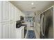 Bright kitchen with white cabinets, stainless steel appliances, and an open layout to the living area at 6748 Fairview Ter # 4-202, Bradenton, FL 34203