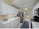 Kitchen with white cabinets, modern appliances, breakfast area, and a view of the backyard at 6748 Fairview Ter # 4-202, Bradenton, FL 34203