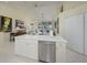 Kitchen island with sink, stainless dishwasher, and a view of open floor plan to dining and living areas at 6748 Fairview Ter # 4-202, Bradenton, FL 34203