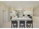 Open kitchen with white cabinets, stainless steel appliances, pendant lighting, and breakfast bar with seating at 6748 Fairview Ter # 4-202, Bradenton, FL 34203