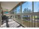 Large screened lanai featuring waterfront views, seating, and an outdoor ceiling fan at 6748 Fairview Ter # 4-202, Bradenton, FL 34203