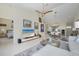 Bright and airy living room with high ceilings, fan, neutral decor, and open floor plan to kitchen and dining at 6748 Fairview Ter # 4-202, Bradenton, FL 34203