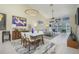 Bright and airy living room/dining room combo with tile floors, ceiling fan, and high ceilings at 6748 Fairview Ter # 4-202, Bradenton, FL 34203