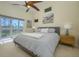 Spacious main bedroom with ceiling fan, recessed lights, art, and views of backyard and water at 6748 Fairview Ter # 4-202, Bradenton, FL 34203