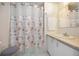 Cozy bathroom featuring a seashell-patterned shower curtain, white vanity, and a mirror at 1005 45Th E Ave, Ellenton, FL 34222